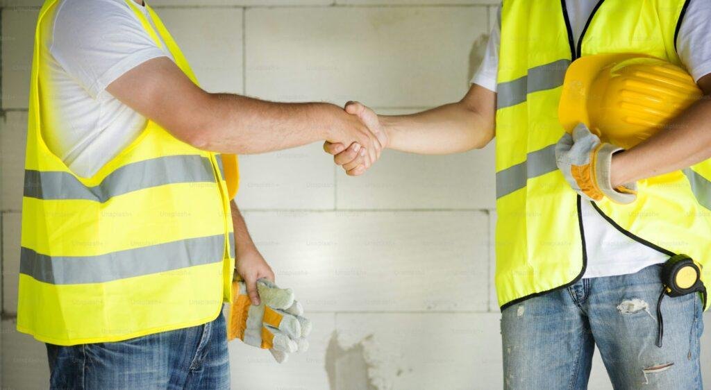 coworkers discussing plans at a job site