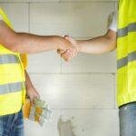 coworkers discussing plans at a job site